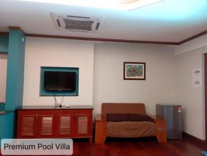 a living room with a couch and a tv at ALPINE GLX PD Port Dickson in Port Dickson