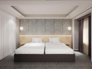 a bedroom with two beds with white sheets at Super Hotel Osaka Natural Hot Springs in Osaka