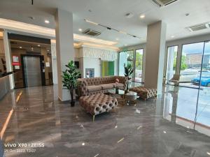 a lobby with couches and a table in a building at Hotel Golden View Nilai in Nilai