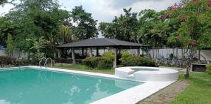 a swimming pool in a yard with a gazebo at G-Hotel Luxury Villa Resort & Hot Spring in Anos
