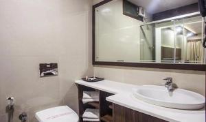 a bathroom with a sink and a toilet at FabHotel Prime Hema's Supreme in Visakhapatnam