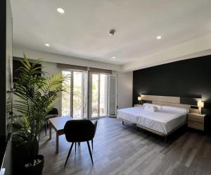 a bedroom with a white bed and a black wall at LEYENDA DEL HEREJE in Seville