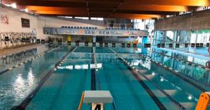 a large swimming pool in a large building at Marine Sea View in Sanremo