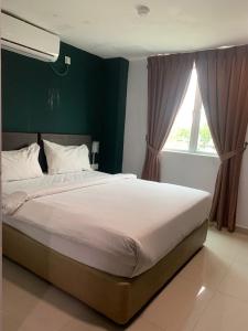 Postel nebo postele na pokoji v ubytování Room V Jalan Megat by SECOM + 6 fotografií