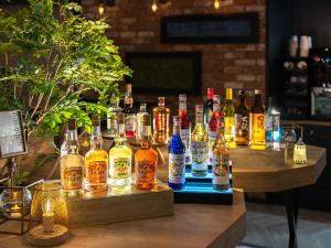 a group of bottles of alcohol on a table at Super Hotel Osaka Natural Hot Springs in Osaka