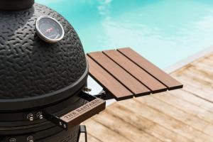 a grill with a watch on it next to a pool at Resort de Weelderik in Hengelo