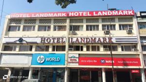 a large hotel building with signs on the front of it at Hotel Landmark in Chandīgarh