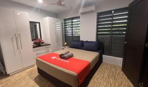 a bedroom with a bed with a camera on it at GreyStone Apartments in Nadi +69 photos