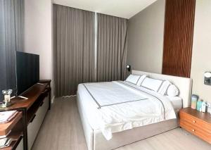 a bedroom with a bed and a desk and a television at NEW Charming 2BR Apartment in Central Jakarta in Jakarta