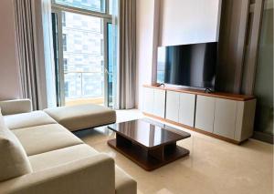a living room with a couch and a flat screen tv at NEW Charming 2BR Apartment in Central Jakarta in Jakarta