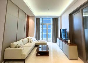 a living room with a couch and a tv at NEW Charming 2BR Apartment in Central Jakarta in Jakarta