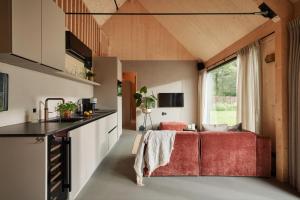 a kitchen and living room in a tiny house at Resort de Weelderik in Hengelo