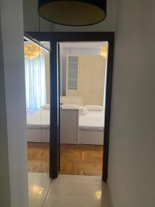 a mirror in a room with a bedroom and a bed at SERAFINA HOME in Thessaloniki
