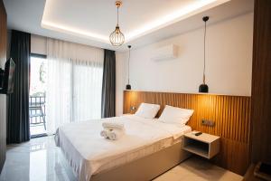 a bedroom with a large bed with a wooden headboard at Vira Apart Suites in Göcek +37 photos