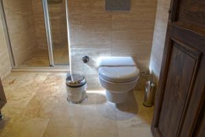 a bathroom with a toilet and a shower at Ages in Cappadocia in Uçhisar