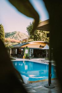 a view of a swimming pool with an umbrella at Vira Apart Suites in Göcek