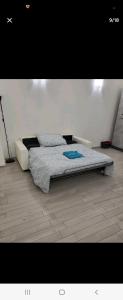 a bedroom with two beds on a wooden floor at Home in City/Airport in Bologna