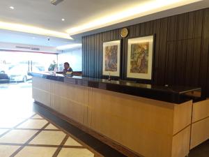 a lobby with a long counter in a building at Kinabalu Daya Hotel in Kota Kinabalu