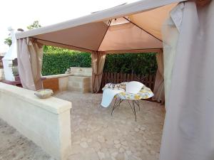 a tent with two chairs and a bath tub at Mariella House in Fasano