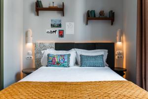 a bedroom with a large bed with pillows on it at Kraft Hotel in Paris