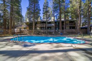an empty swimming pool in front of a house at #525 Walk to Golf Course, Midtown, Stunning Condo in Mammoth Lakes