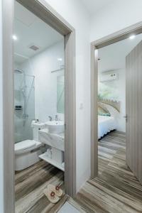 a bathroom with a sink and a toilet and a bed at Su Casa Hanoi Old Quarter in Hanoi +103 photos
