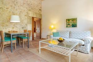 a living room with a couch and a table at Agroturismo sa Rota d' en Palerm in Lloret de Vistalegre