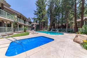 a swimming pool in the courtyard of a house at #359 - Mountain Condo, Walk to Shops with Pool, Spa, & Game Room in Mammoth Lakes