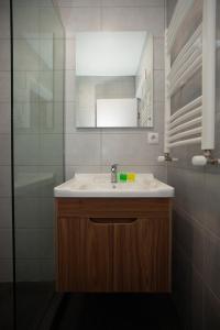 a bathroom with a sink and a mirror at Old City Boutique Hotel in Tbilisi City