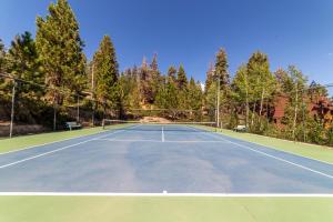 a tennis court with trees in the background at #278 Ski-in, Ski-out Corner unit with View in Mammoth Lakes