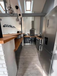 a kitchen with stainless steel appliances and a window at Les toits d'Albatre in Dieppe