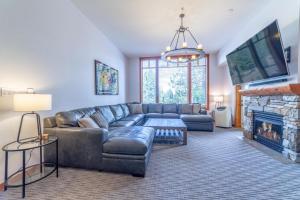 a living room with a couch and a fireplace at #550 Village, Walk to Gondola 3BD, 3BATH with Spa in Mammoth Lakes
