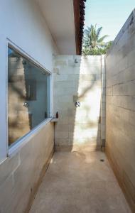a room with a window and a concrete wall at 3 Bedroom Private House in Gili Trawangan