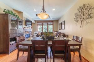 a kitchen and dining room with a table and chairs at 506 Village Condo Steps to Gondola in Mammoth Lakes