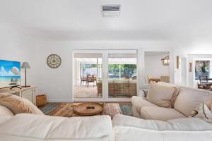 a white living room with a couch and a table at 265 Gladiolus Home in Anna Maria