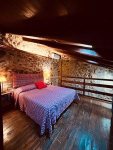 a bedroom with a bed in a stone wall at I Casali della Parata in Velletri