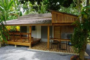 a small house with a table and chairs in front of it at Thong Tiny House in Phatthalung