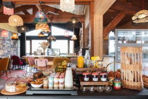 a bakery with a counter with food on it at Mamie Megève in Megève +86 photos