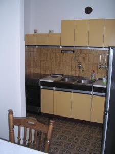 a kitchen with a sink and a stove at Apartments Ajka in Tisno +21 photos