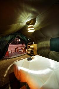 a room with a bed in a tent at Nujoum Overnight Camp with Signature Desert Safari in Dubai