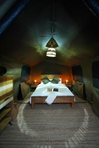 a bedroom with a bed in a tent at Nujoum Overnight Camp with Signature Desert Safari in Dubai