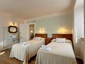 a room with two beds with towels on them at ETXEALE in Valcarlos