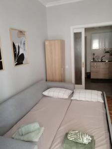 a large white bed in a room with a kitchen at City Center Beauty in Serres