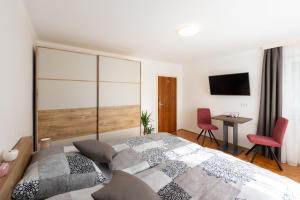 ein Schlafzimmer mit einem großen Bett und einem Schreibtisch in der Unterkunft Appartement Annis Murtalblick in Sankt Margarethen im Lungau