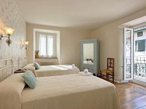 a room with three beds and a window at ETXEALE in Valcarlos +46 photos