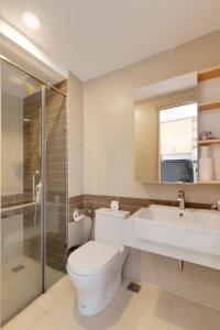 a bathroom with a toilet and a sink and a shower at Saigon Authentic Apartments - Amazing Infinity Pool and FREE Daily Breakfast Voucher, Walking Tour and 4G SIM card for 3 nights booking in Ho Chi Minh City