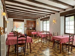 a dining room with red and white tables and chairs at ETXEALE in Valcarlos