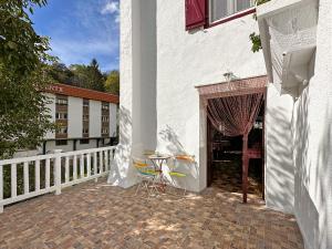 a patio with two chairs and a table on a building at ETXEALE in Valcarlos