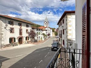 a car parked on a street in a town with a church at ETXEALE in Valcarlos