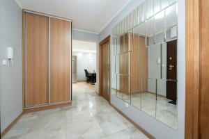 a hallway with glass doors and a dining room at Luxury in the City-10-KsiezyMlyn&GaleriaLodzka in Łódź